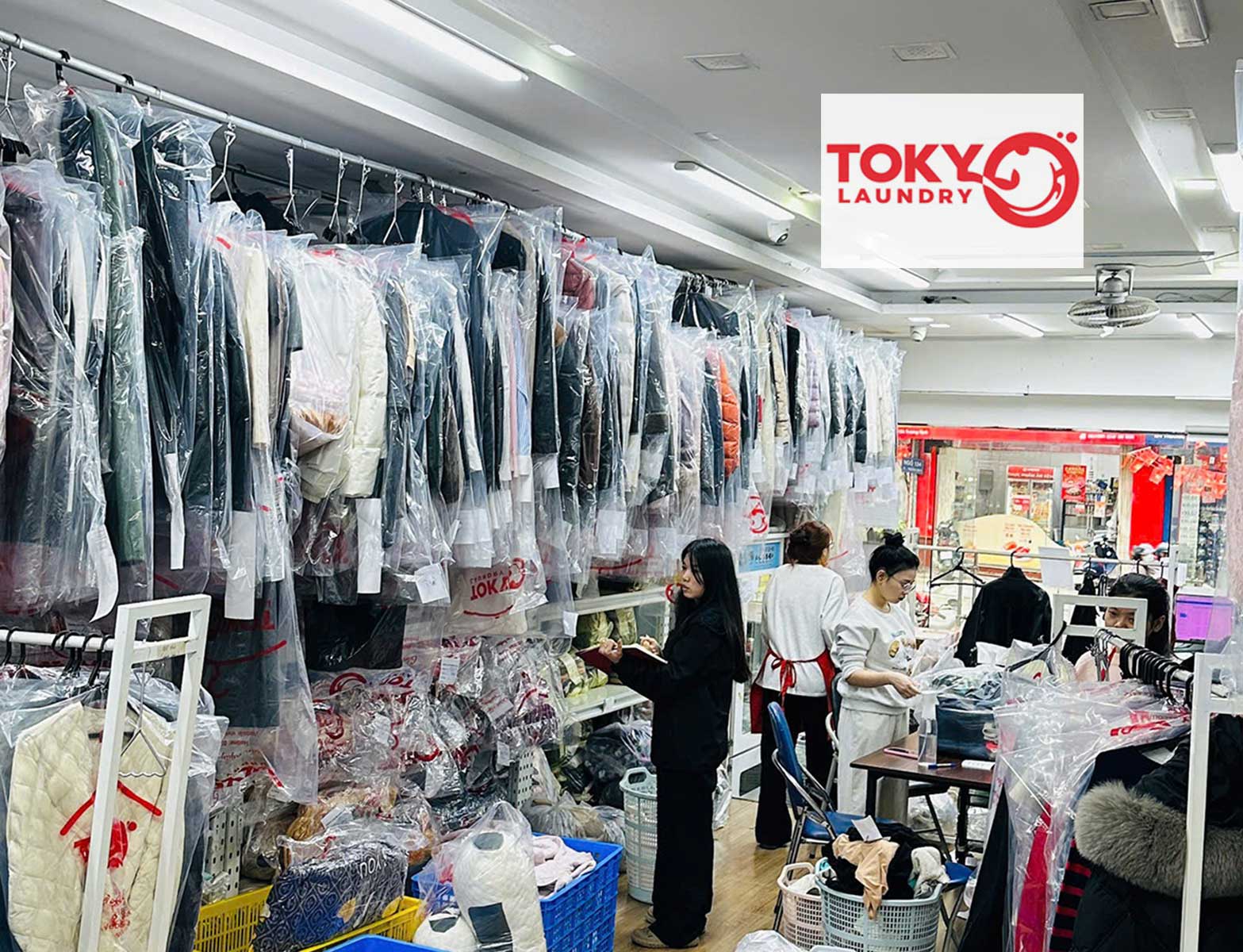 Trang phục được bọc túi bảo quản cẩn thận trên giá treo tại tiệm giặt áo vest tại Thanh Nhàn